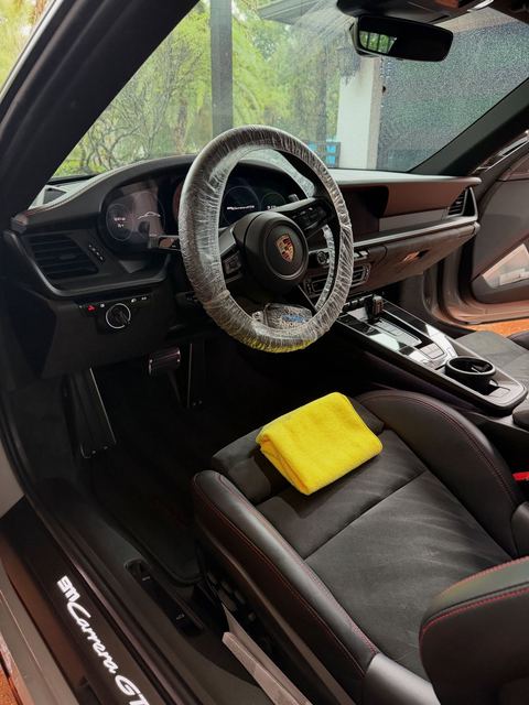 Porsche 911 interior detailed, steering wheel covered during service